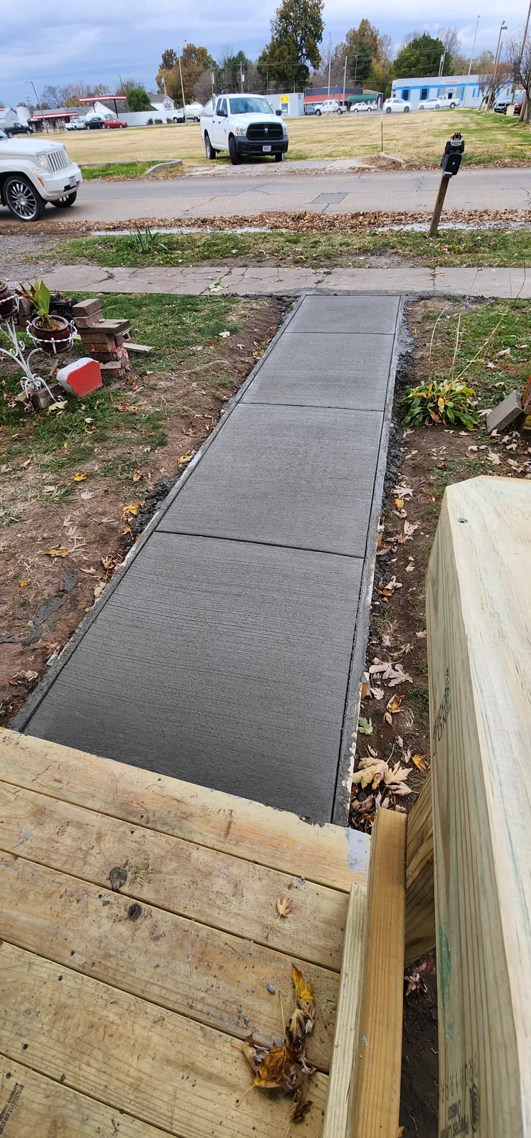 Freshly poured concrete walkway with wooden forms